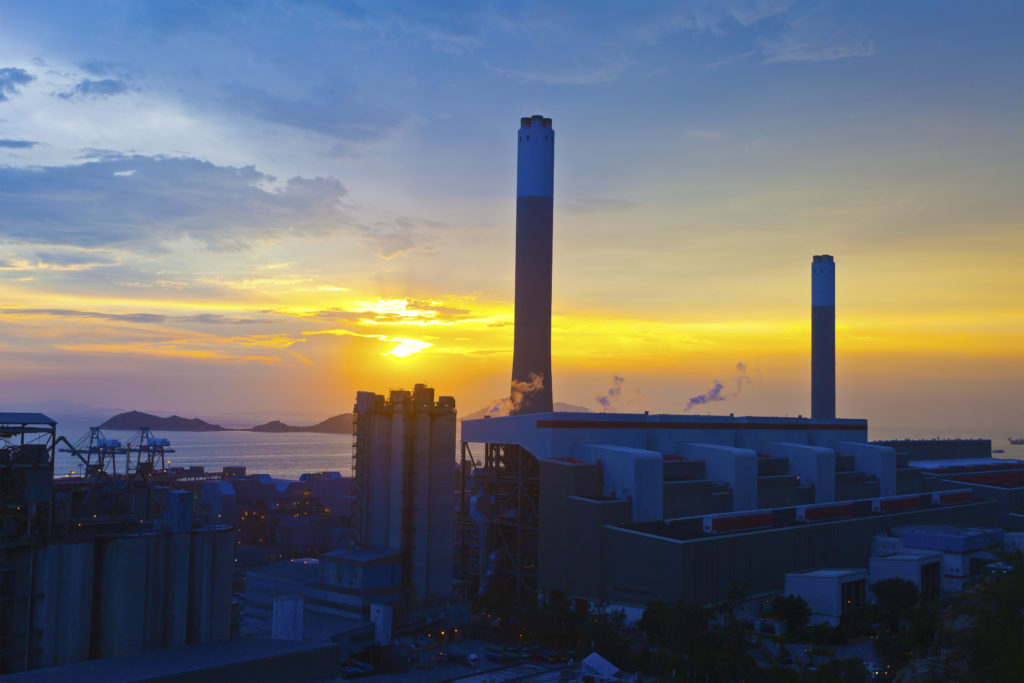 power plant at sunset by the water