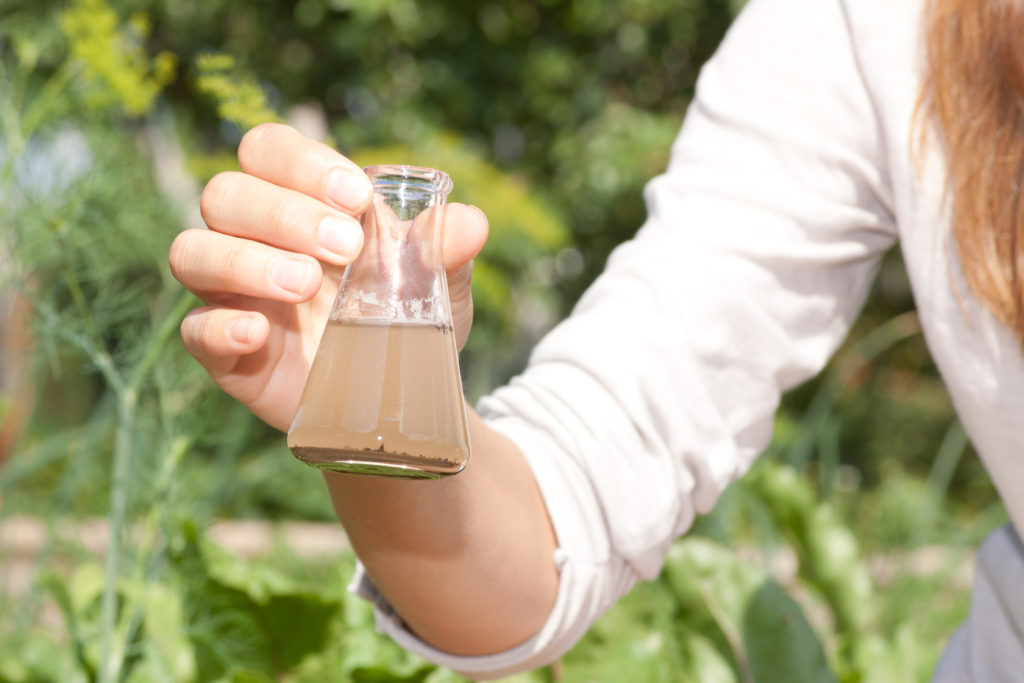 woman holding test flask