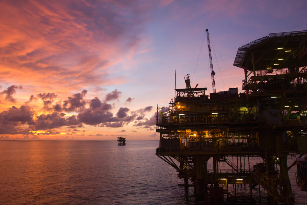 oil rig at dusk in the ocean
