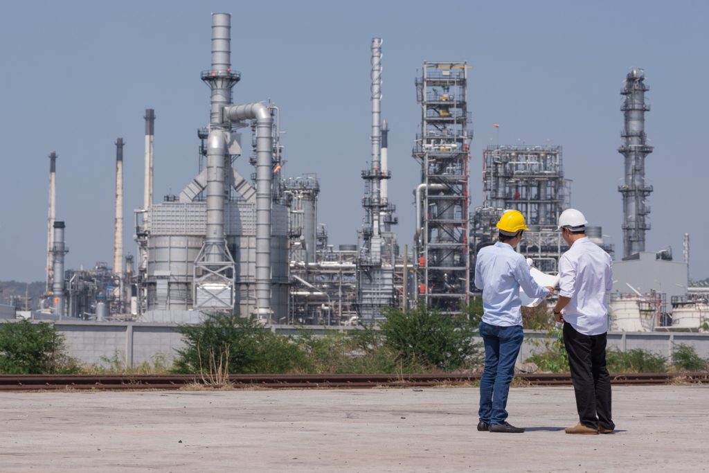 engineers reviewing plans outside plant